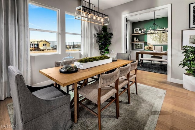 dining area with light wood-style flooring and baseboards