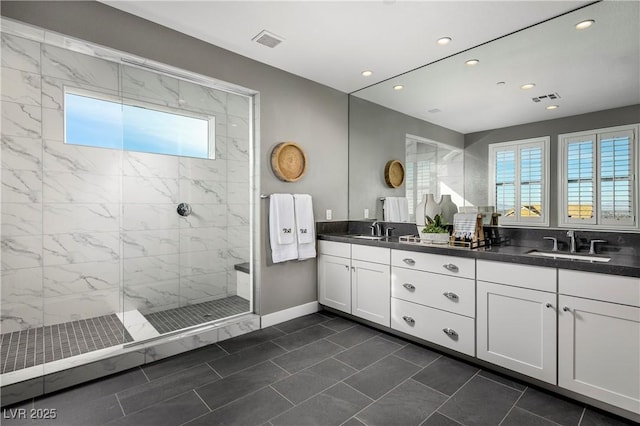 bathroom featuring plenty of natural light, a sink, and visible vents