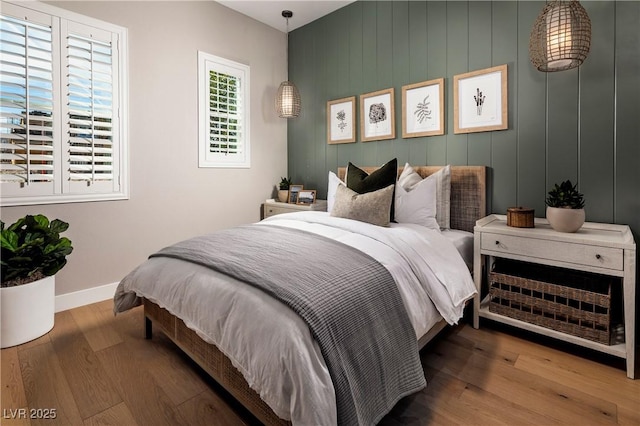 bedroom featuring wood finished floors and baseboards