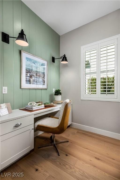 home office with light wood-style floors and baseboards