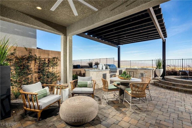 view of patio with outdoor dining area, grilling area, an outdoor kitchen, a ceiling fan, and a fenced backyard