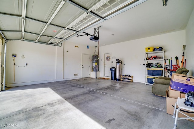 garage featuring a garage door opener and secured water heater