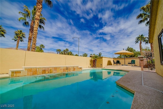 view of swimming pool featuring a patio area, a fenced backyard, and a fenced in pool