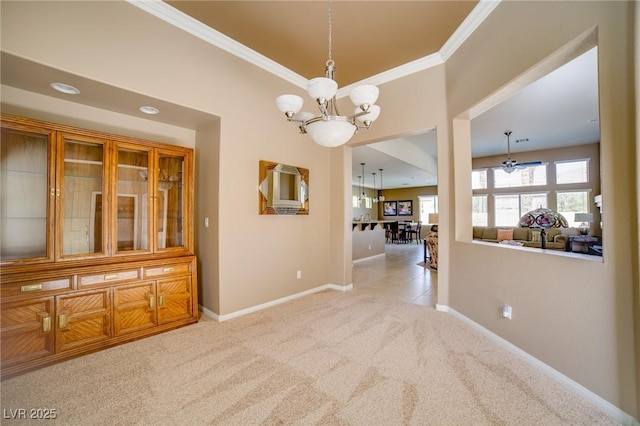 interior space featuring a chandelier, carpet flooring, crown molding, and baseboards