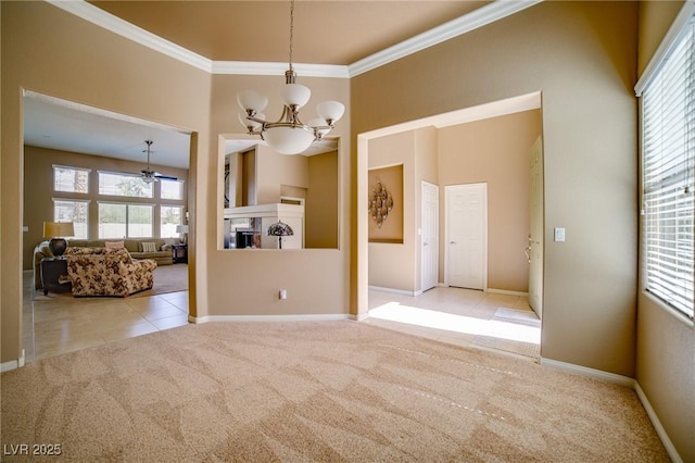 carpeted empty room with ornamental molding, a fireplace, a towering ceiling, and tile patterned floors