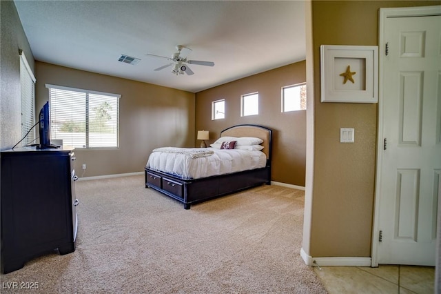 bedroom with baseboards, visible vents, ceiling fan, and light colored carpet