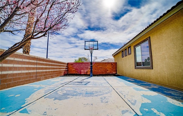 view of sport court with a fenced backyard