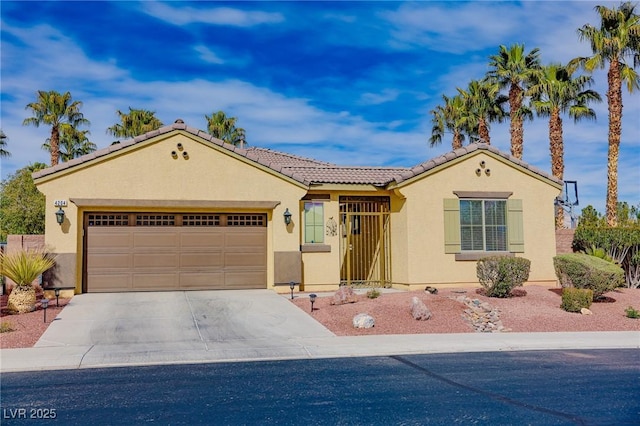 view of front of house with an attached garage, driveway, a tiled roof, and stucco siding