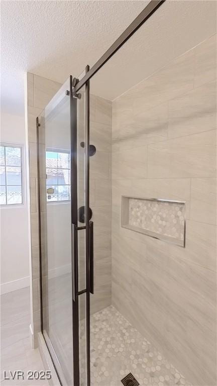 full bath with a stall shower and a textured ceiling