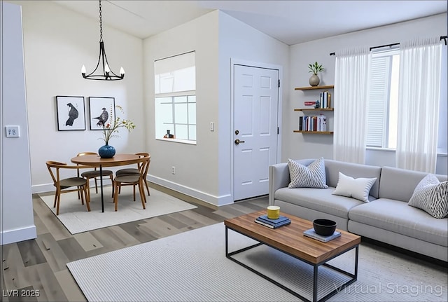 1624 N Torrey Pines Dr Unit 101, Las Vegas, NV 89108 - living area featuring baseboards, wood finished floors, and a chandelier