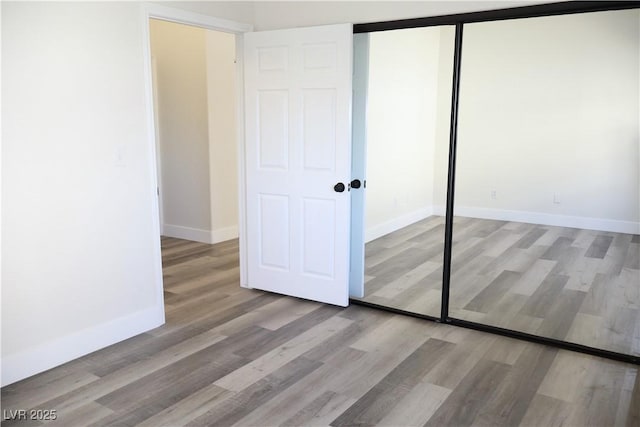 1624 N Torrey Pines Dr Unit 101, Las Vegas, NV 89108 - unfurnished bedroom featuring wood finished floors, a closet, and baseboards