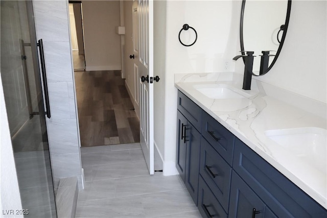 1624 N Torrey Pines Dr Unit 101, Las Vegas, NV 89108 - bathroom featuring double vanity, baseboards, and tile patterned floors