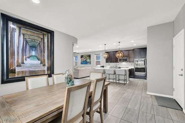 dining room featuring light tile patterned floors, baseboards, and recessed lighting