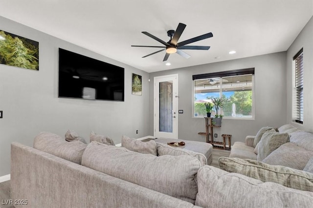 living area featuring baseboards, a ceiling fan, and recessed lighting