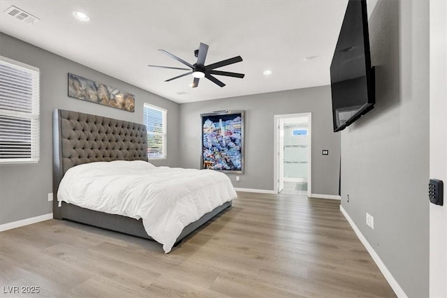 bedroom featuring baseboards, wood finished floors, and recessed lighting