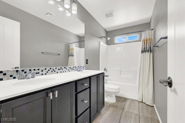 bathroom with double vanity, visible vents, and a sink