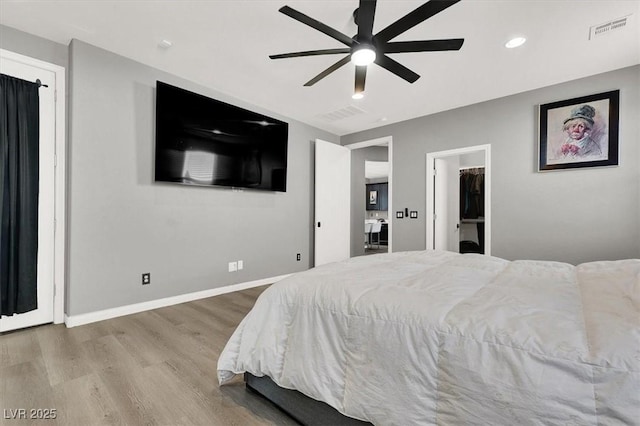 bedroom featuring baseboards, visible vents, wood finished floors, and recessed lighting