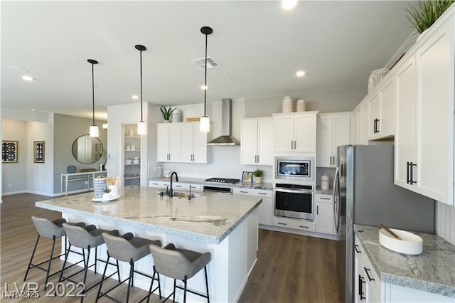 6324 Zephyr Ct, Las Vegas, NV 89149 - kitchen featuring dark wood-style floors, wall chimney range hood, white cabinetry, and stainless steel appliances