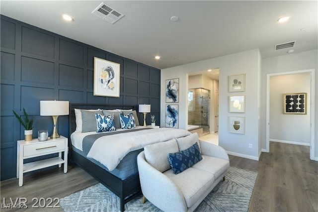 6324 Zephyr Ct, Las Vegas, NV 89149 - bedroom featuring baseboards, visible vents, wood finished floors, and a decorative wall