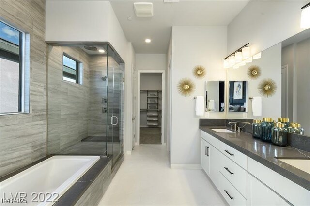6324 Zephyr Ct, Las Vegas, NV 89149 - bathroom with a sink, a tub, a stall shower, double vanity, and baseboards