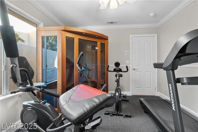 exercise area featuring visible vents, crown molding, and baseboards