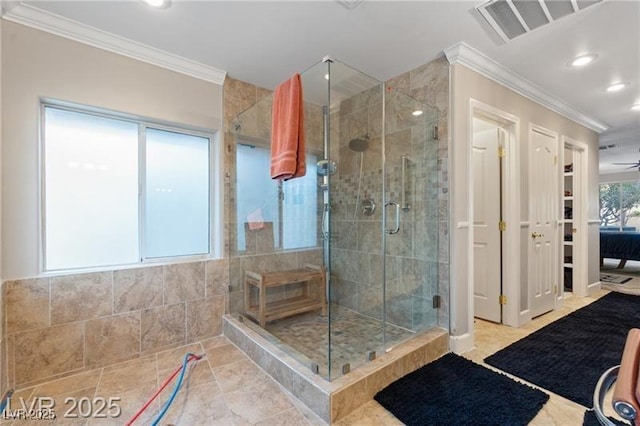 bathroom featuring a shower stall, visible vents, and crown molding