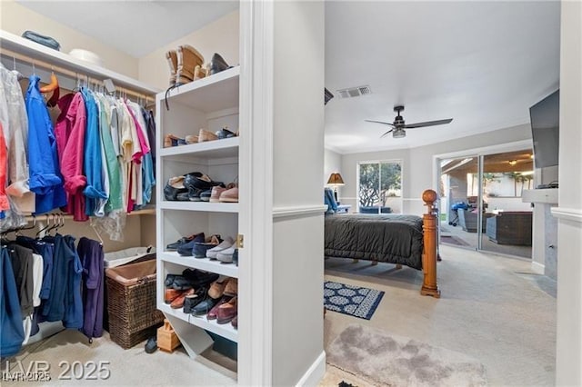 walk in closet featuring ceiling fan and visible vents