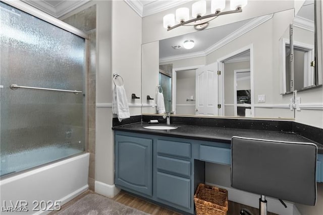 full bathroom with combined bath / shower with glass door, ornamental molding, wood finished floors, and vanity