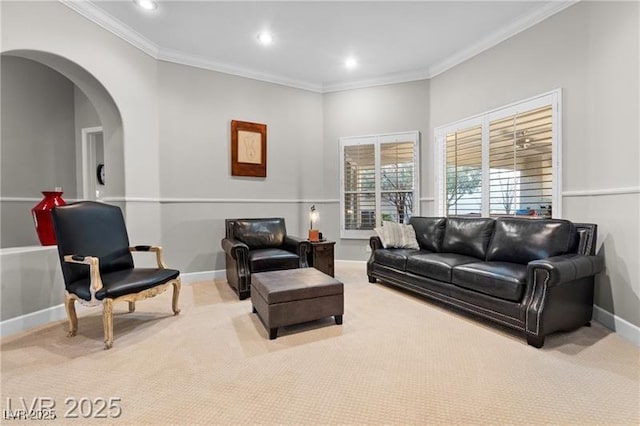 carpeted living room featuring arched walkways, ornamental molding, recessed lighting, and baseboards