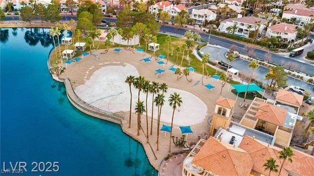 birds eye view of property with a water view and a residential view