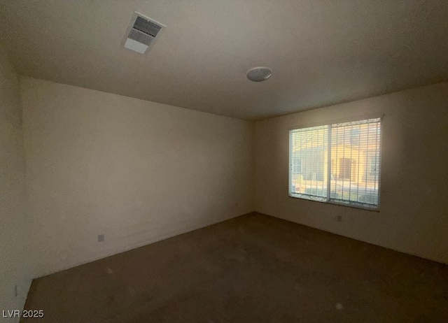 empty room with carpet floors and visible vents