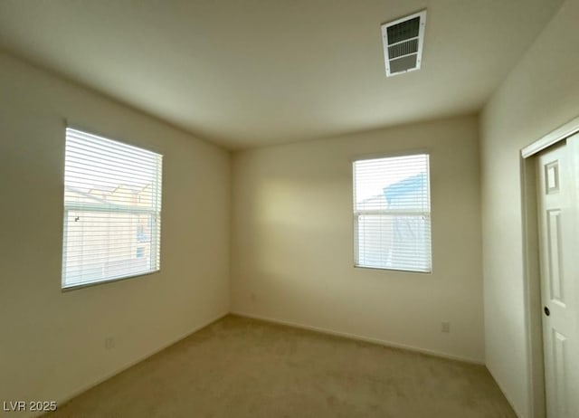 carpeted spare room with visible vents