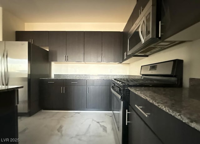 kitchen with marble finish floor, stone countertops, and appliances with stainless steel finishes