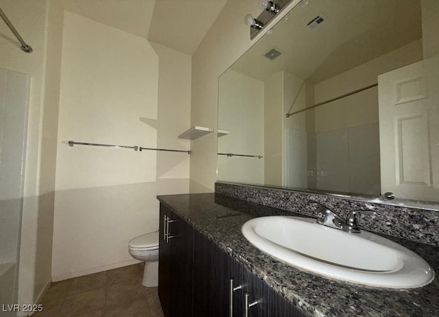 bathroom with a shower, visible vents, toilet, vanity, and tile patterned flooring