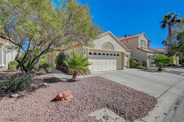 mediterranean / spanish-style house featuring driveway, a tiled roof, an attached garage, and stucco siding