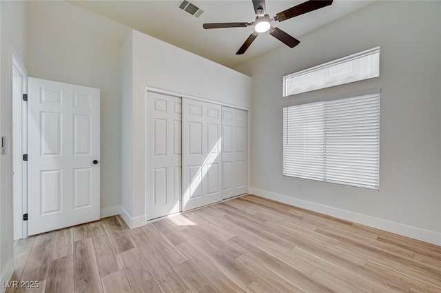 unfurnished bedroom with a closet, visible vents, light wood-style floors, a ceiling fan, and baseboards