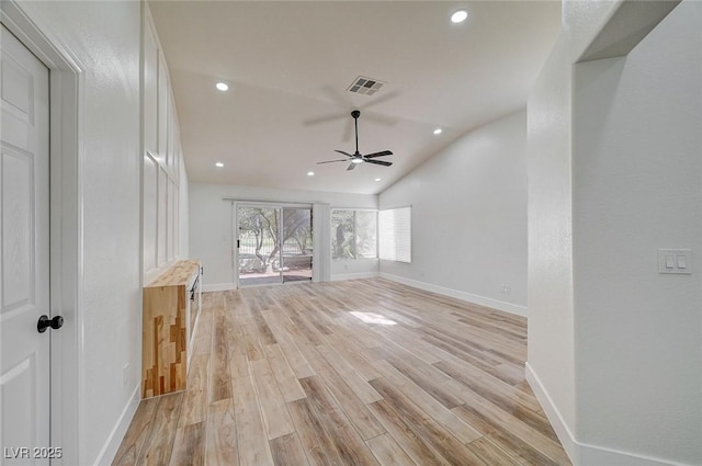 unfurnished living room with lofted ceiling, baseboards, visible vents, and light wood finished floors