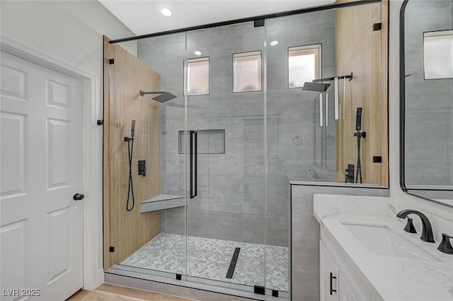 bathroom with a shower stall and vanity