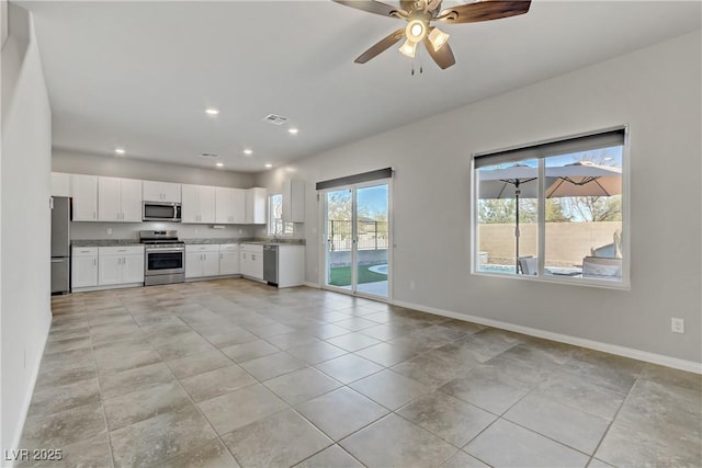 kitchen with white cabinetry, visible vents, appliances with stainless steel finishes, and baseboards