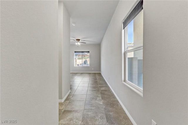 hallway featuring baseboards