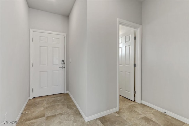 interior space with stone finish floor and baseboards