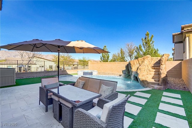 view of patio / terrace featuring a fenced backyard and a pool with connected hot tub