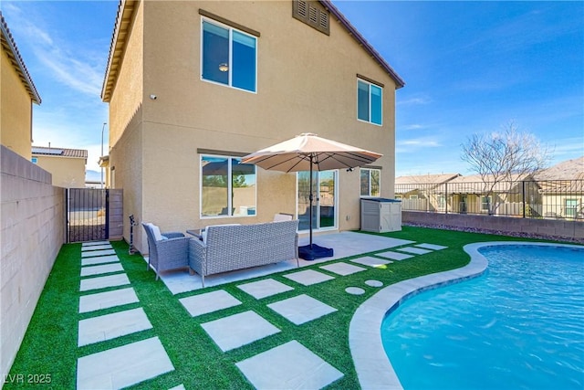 back of house with fence private yard, a patio area, and stucco siding