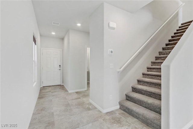 stairway featuring baseboards and recessed lighting