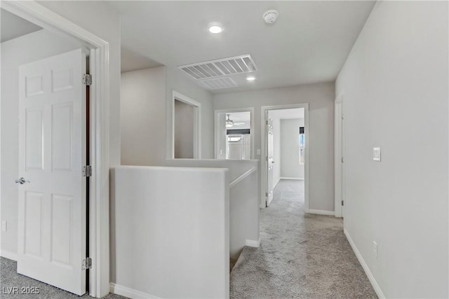 hallway featuring recessed lighting, visible vents, light carpet, an upstairs landing, and baseboards