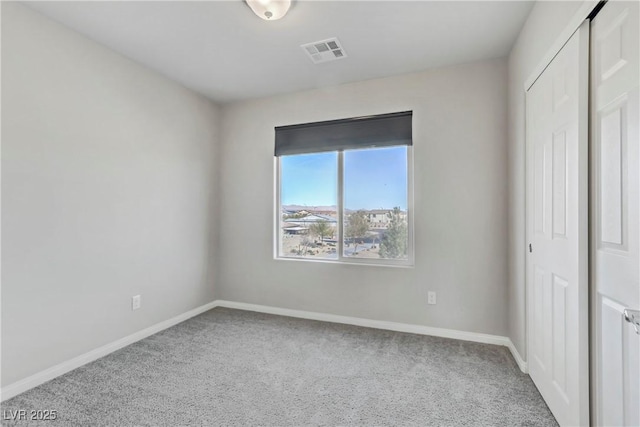 interior space featuring baseboards, visible vents, and carpet flooring