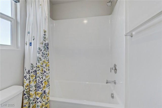 bathroom featuring shower / bathtub combination with curtain and toilet