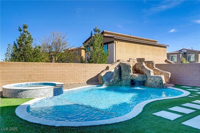 view of pool with a fenced backyard and a pool with connected hot tub