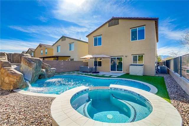 view of swimming pool with a patio, central AC unit, a fenced backyard, and a pool with connected hot tub