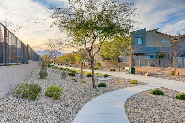 surrounding community with fence and a residential view